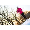 Young woman running outdoors on a cold winter day