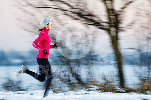 Young woman running outdoors on a cold winter day (motion blurred image) Young woman running outdoors on a cold winter day (motion blurred image)