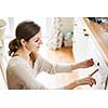 Housework: young woman putting dishes in the dishwasher