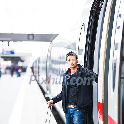 Train travel - Handsome young man taking a train Train travel - Handsome young man taking a train