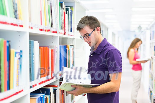 Handsome college student in library (shallow DOF; color toned image) Handsome college student in library (shallow DOF; color toned image)