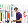 Handsome college student in library (shallow DOF; color toned image)