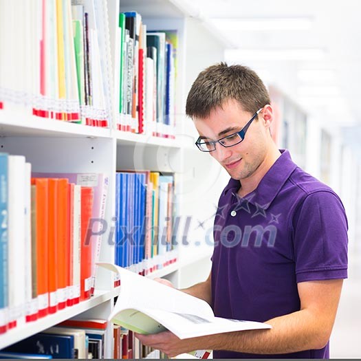 Handsome college student in library (shallow DOF; color toned image) Handsome college student in library (shallow DOF; color toned image)