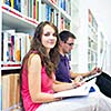 Two college students in library (color toned image; shallow DOF)