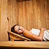 Young woman relaxing in a sauna