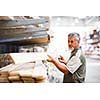 Senior man buying construction wood in a  DIY store