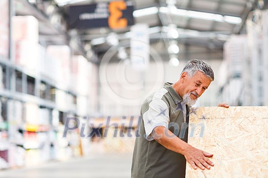 Senior man buying construction wood in a DIY store Senior man buying construction wood in a DIY store