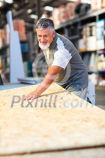 Senior man buying construction wood in a DIY store Senior man buying construction wood in a DIY store