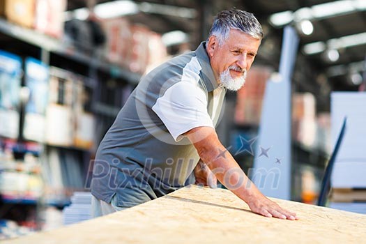 Senior man buying construction wood in a DIY store Senior man buying construction wood in a DIY store