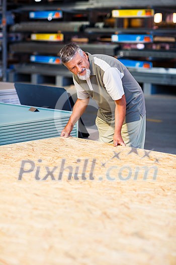 Senior man buying construction wood in a DIY store Senior man buying construction wood in a DIY store