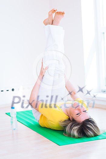 Pretty young woman doing YOGA exercise at home Pretty young woman doing YOGA exercise at home