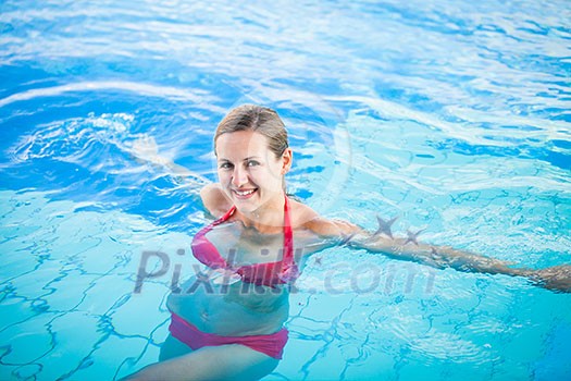 Portrait of a young woman relaxing in a swimming pool (shallow DOF; color toned image) Portrait of a young woman relaxing in a swimming pool (shallow DOF; color toned image)