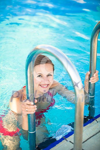 Portrait of a young woman relaxing in a swimming pool (shallow DOF; color toned image) Portrait of a young woman relaxing in a swimming pool (shallow DOF; color toned image)