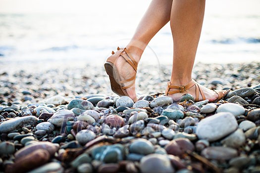 Young woman on the beach enjoying a warm summer evening