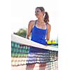 Portrait of a pretty young tennis player on the court