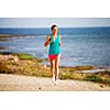 Young woman on her evening jog along the seacoast