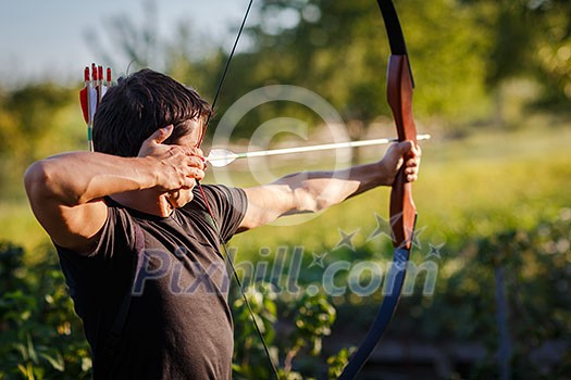 Young archer training with the bow Young archer training with the bow