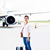 Just arrived: young woman at an airport having just left the aircraft