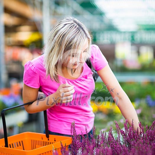 Young woman buying flowers at a garden center Young woman buying flowers at a garden center