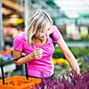 Young woman buying flowers at a garden center