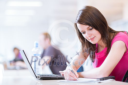 in the library - pretty female student with laptop and books working in a high school library (color toned image) in the library - pretty female student with laptop and books working in a high school library (color toned image)