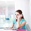 Pretty young woman using her mobile phone/speaking on the phone in a public area (shallow DOF; color toned image)