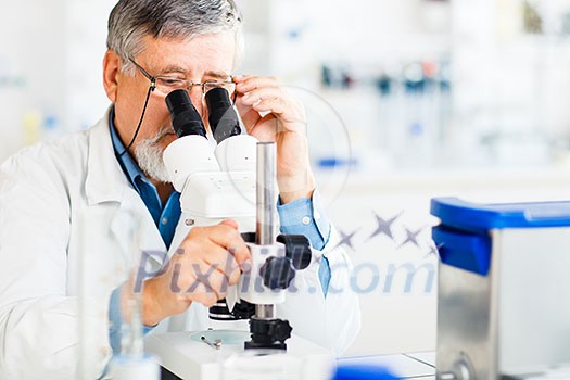 senior male researcher carrying out scientific research in a lab using a microscope (shallow DOF; color toned image) senior male researcher carrying out scientific research in a lab using a microscope (shallow DOF; color toned image)