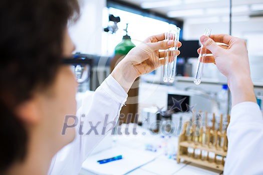 Young male researcher carrying out scientific research in a lab (shallow DOF; color toned image) Young male researcher carrying out scientific research in a lab (shallow DOF; color toned image)