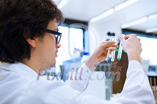 Young male researcher carrying out scientific research in a lab (shallow DOF; color toned image) Young male researcher carrying out scientific research in a lab (shallow DOF; color toned image)