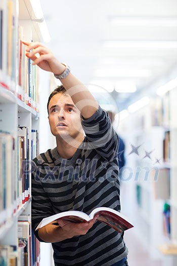 handsome young college student in a library (shallow DOF; color toned image) handsome young college student in a library (shallow DOF; color toned image)