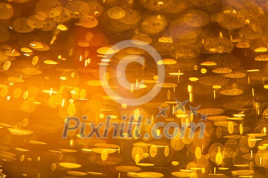 Golden macro background: gas bubbles in beer at shallow DOF against sunlight Golden macro background: gas bubbles in beer at shallow DOF against sunlight