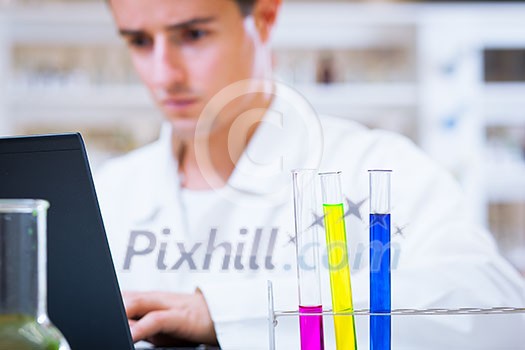 close-up portrait of a young male researcher carrying out experiments in a chemistry research lab (color toned image) close-up portrait of a young male researcher carrying out experiments in a chemistry research lab (color toned image)
