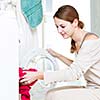 Housework: young woman doing laundry (shallow DOF; color toned image)