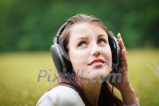 portrait of a pretty young woman listening to music on her mp3 player outdoors (daydreaming) portrait of a pretty young woman listening to music on her mp3 player outdoors (daydreaming)