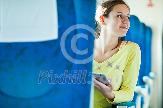 Young woman using her tablet computer while traveling by train Young woman using her tablet computer while traveling by train