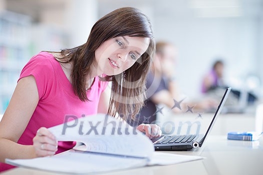 in the library - pretty female student with laptop and books working in a high school library  (color toned image)