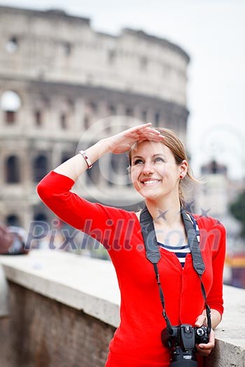 Portrait of a pretty young tourist taking photographs while sightseeing in Rome, Italy (with Colosseum in the background) Portrait of a pretty young tourist taking photographs while sightseeing in Rome, Italy (with Colosseum in the background)