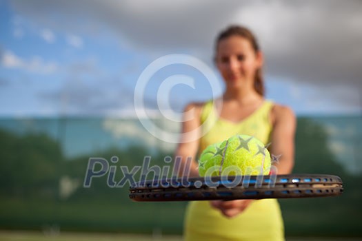 pretty, young female tennis player on the tennis court (shallow DOF, selective focus) pretty, young female tennis player on the tennis court (shallow DOF, selective focus)