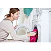 Housework: young woman doing laundry (shallow DOF; color toned image)