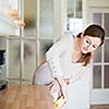 Young woman doing housework, cleaning the kitchen