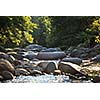 Mountain river in Restonica Valley, Corsica, France, lit by warm morning sunlight