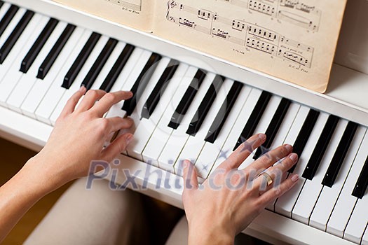 Playing Piano (shallow DOF; color toned image) Playing Piano (shallow DOF; color toned image)
