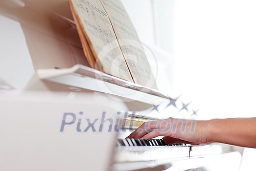 Playing Piano (shallow DOF; color toned image) Playing Piano (shallow DOF; color toned image)