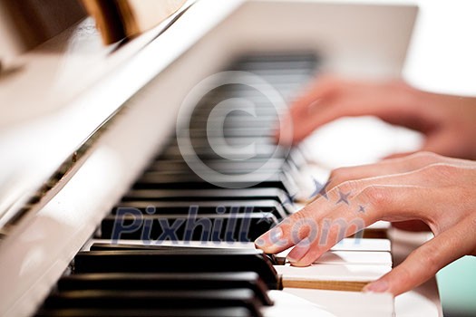 Playing Piano (shallow DOF; color toned image) Playing Piano (shallow DOF; color toned image)