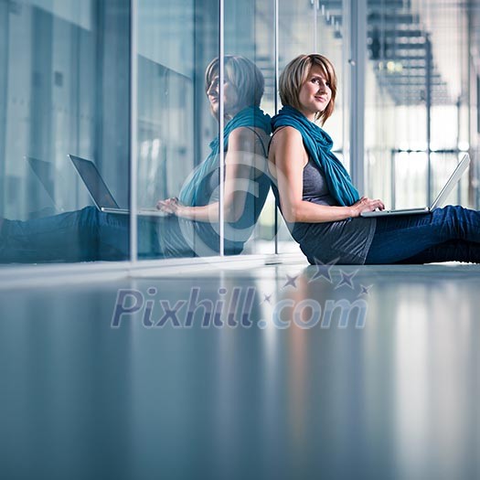 Pretty young female student with a laptop computer on college/university campus (shallow DOF; color toned image) Pretty young female student with a laptop computer on college/university campus (shallow DOF; color toned image)