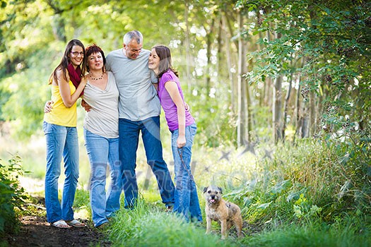 Family portrait - Family of four with a cute dog outdoors Family portrait - Family of four with a cute dog outdoors