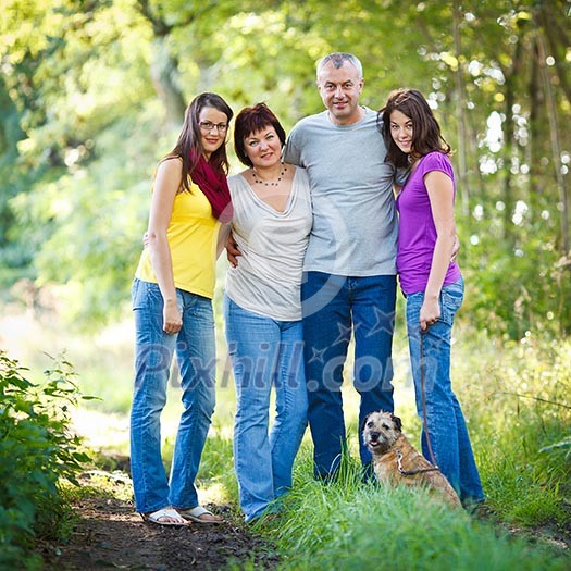 Family portrait - Family of four with a cute dog outdoors Family portrait - Family of four with a cute dog outdoors