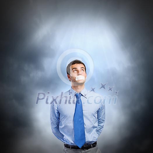 Young handsome businessman with adhesive tape on mouth Young handsome businessman with adhesive tape on mouth