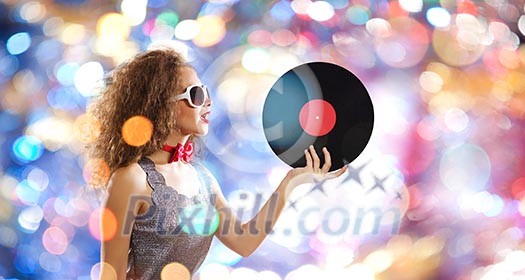 Young pretty girl dj at disco party holding vinyl