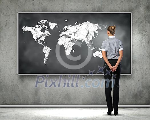 Rear view of businesswoman looking at chalkboard Rear view of businesswoman looking at chalkboard